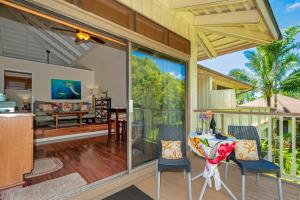 an open patio with a table and chairs on a porch at Paniolo 210B in Princeville