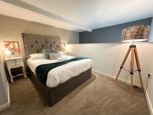 a bedroom with a large bed and a tripod at Align Lux Apartments, Liverpool City Centre in Liverpool