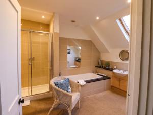 a bathroom with a bath tub and a sink at Goss Hall in Canterbury +80 photos