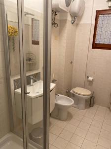 a bathroom with a toilet and a sink and a shower at La Casa al Mare di Giulia in Porto Potenza Picena +25 photos
