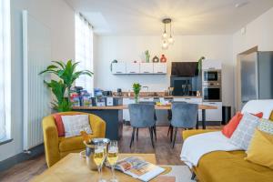 a living room with a couch and a table at La Plume de Colbert - By PrestiPlace in Tours