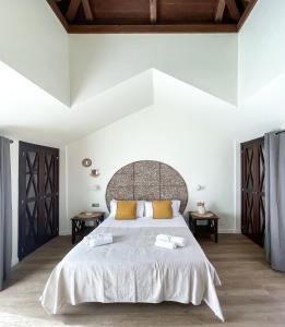 a bedroom with a large bed with two tables at Casa Dorada by Best Holidays Fuerteventura in Corralejo