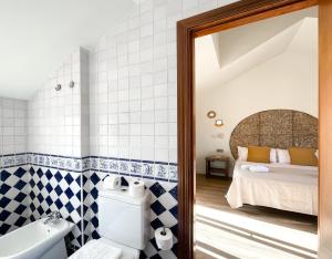 a bathroom with a bed and a toilet and a tub at Casa Dorada by Best Holidays Fuerteventura in Corralejo +37 photos
