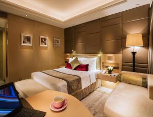 a hotel room with a bed and a desk at Gloucester Luk Kwok Hong Kong in Hong Kong