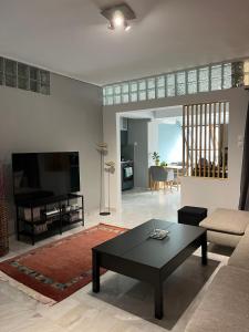 a living room with a couch and a coffee table at Central loft D5 in Volos