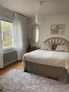a bedroom with a large bed and a window at 2 bedroom house central Parainen in Pargas