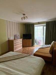a bedroom with two beds and a flat screen tv at Gazelle 1 in Mykolaiv