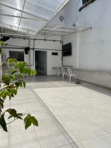 a large room with white chairs and a table at ABA Hotel in Belém