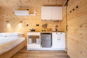 a bedroom with a bed and a small kitchen at Nest Away in Strängnäs