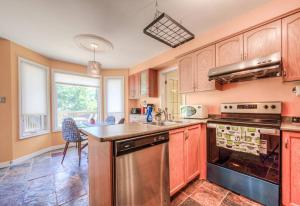 a kitchen with wooden cabinets and a stainless steel appliance at 45 per Off Monthly Stay - 7 Beds - BBQ in Kitchener