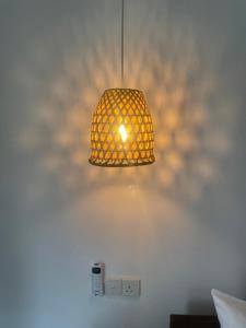 a lamp on a wall with a light on it at Villa Hideout in Weligama