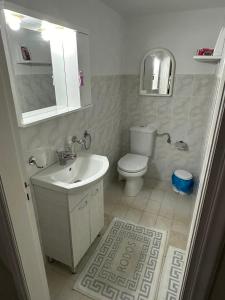 a bathroom with a toilet and a sink at Giulia's Beach House in Rhodes Town