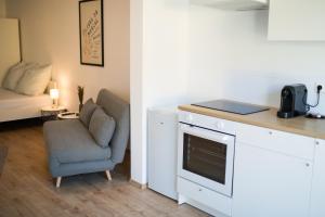 a kitchen with a chair and a counter with a stove at HUGOS Studio Apartment in Bensheim