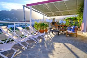 a group of chairs and tables on a balcony at Casa Luisa in Teror