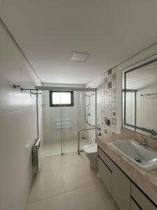 a bathroom with a sink and a shower and a toilet at Ville Del Bosco Hotel in São Marcos +38 photos