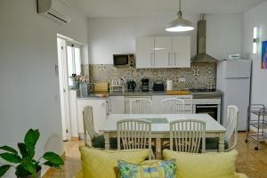 a kitchen with a table and chairs in a room at Casa Luisa in Teror