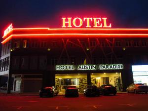 a hotel with cars parked outside of it at night at Hotel Austin Paradise in Johor Bahru