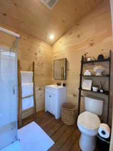 a log cabin bathroom with a toilet and a sink at The Green Acres Cabin in Hamilton +48 photos