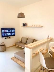 a living room with a couch and a table at Casa da Leoa in Sal Rei +8 photos