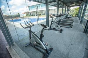 a row of exercise bikes parked next to a swimming pool at VIP Hotel Segamat in Segamat
