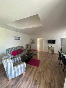a living room with a couch and a table at Fewo Müritz Engel in Klink