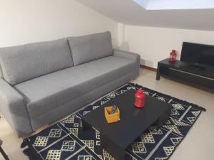 una sala de estar con un sofá y una mesa en Atico Finisterre, en Finisterre