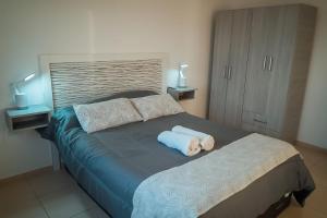 a bedroom with a bed with a dog laying on it at AROMA DEL POTRERO PISCINA CLIMATIZADA CUBIERTA disponible desde Septiembre in Potrero de los Funes +24 photos