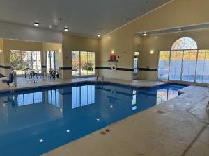 a large swimming pool in a large house at Country Inn & Suites by Radisson, Beckley, WV in Beckley