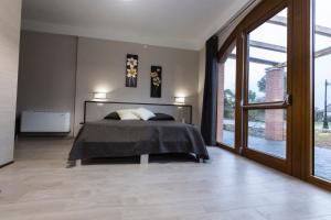 a bedroom with a bed and a large window at La Dolce Mela in Buonabitacolo