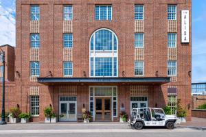 a jeep parked in front of a brick building at The Alida, Savannah, a Tribute Portfolio Hotel in Savannah