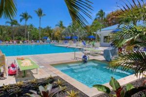 a pool at a resort with palm trees at Toes in the Sand - 2 Bedroom Condo Sleeps 4 in Tavernier