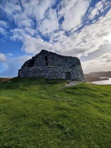 an old stone building on top of a green field at B&B At Forty Three in Vatsker +21 photos