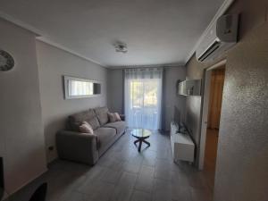 a living room with a couch and a table at Appartement Bella Vista in Rojales