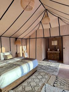 a bedroom with a bed in a tent at Anir Luxury Camp - Gites et Tentes de Luxe in Merzouga