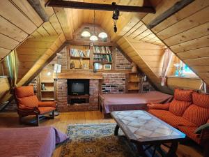 a attic room with two beds and a tv at Käbliku Puhkemajad in Kanepi