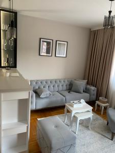 a living room with a couch and a table at Urban Apartman-privatan parking- in Kraljevo