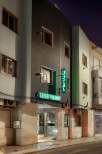 a building with a sign on the side of it at Hotel Nova Cidade in Amadora