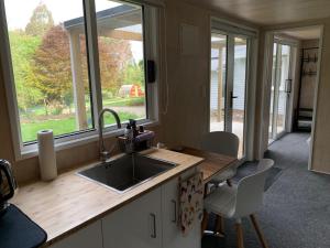 a kitchen with a sink and a window at Herbert Hampden Cottage in Herbert