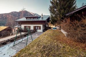 a house with a basketball hoop in front of it at Villa Chiappuzza - Stayincortina in San Vito di Cadore