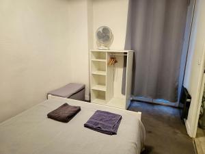 a bedroom with a bed with two towels on it at Le Cocon-T2-Proche du centre-Wifi in Lourdes