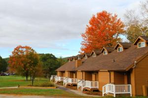 a building with white benches in front of it at Cold Spring Plymouth Resort in Ashland