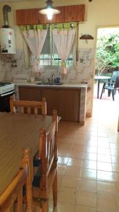 a kitchen with a table and a counter top at Chalet Santa Teresita in Santa Teresita