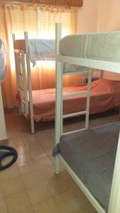 two bunk beds in a room with a window at Chalet Santa Teresita in Santa Teresita