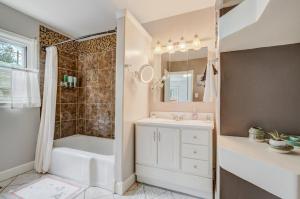 ein Badezimmer mit Badewanne, Waschbecken und Dusche in der Unterkunft Steps to Downtown Eateries & Bars - With Fire Pit! in Colorado Springs