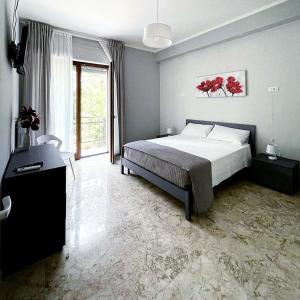 a bedroom with a bed and a large window at B & B Ai Giardinetti in SantʼArsenio