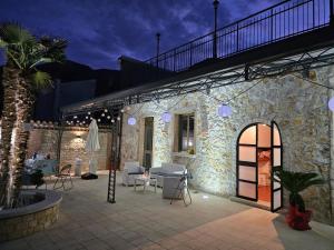 a stone building with a patio with tables and chairs at B & B Ai Giardinetti in SantʼArsenio