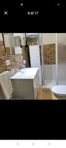 a bathroom with a white sink and a shower at Suit catania1946 in Catania +11 photos