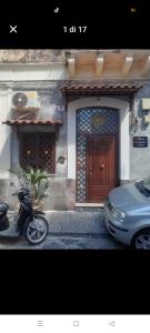 a motorcycle parked in front of a house with a door at Suit catania1946 in Catania