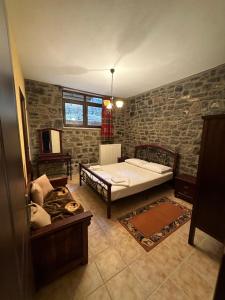a bedroom with a bed and a couch in it at Villazia The Highest in Kardharas