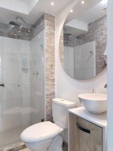 a bathroom with a toilet and a sink and a mirror at Semi-loft Manizales Colombia in Manizales